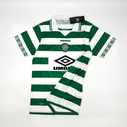 Flat lay of a Celtic FC Umbro shirt with one sleeve folded, displaying the green and white hoops, sleeve pattern, and overall shirt design.