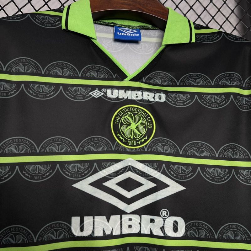 Close-up of the Celtic FC Umbro shirt collar and chest, showing the club crest, Umbro logo, and detailed pattern.