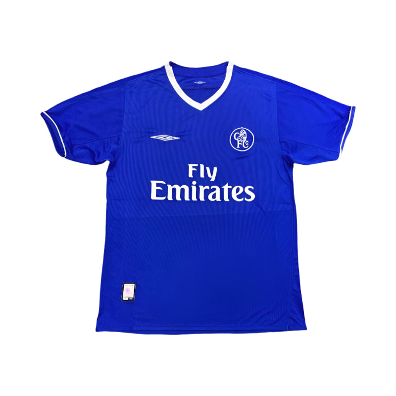 Blue Chelsea FC 2003 football shirt with white Fly Emirates sponsor logo, Umbro logo, and retro circular club crest, laid flat on a plain background.