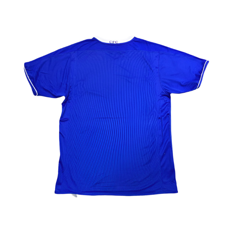 Back view of a blue 2003 Chelsea FC football shirt with white collar and sleeve trim, showing "CFC" text on the collar.