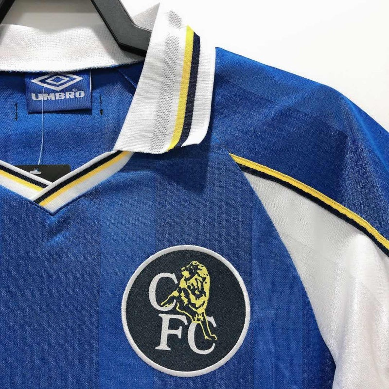 Close-up of the Chelsea FC crest and collar on the 1999 Umbro home shirt, showing the lion logo and shirt texture.
