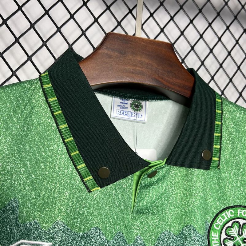 Close-up of the collar of the Celtic FC 1991-1992 away football shirt, showing green and yellow trim, button details, and Umbro label inside the neck.