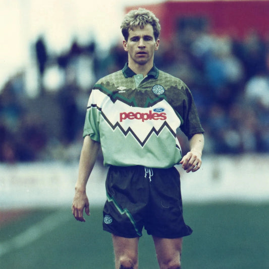 Footballer on the pitch wearing the full Celtic FC 1991-1992 away kit, including shirt, shorts, and socks, during a match.